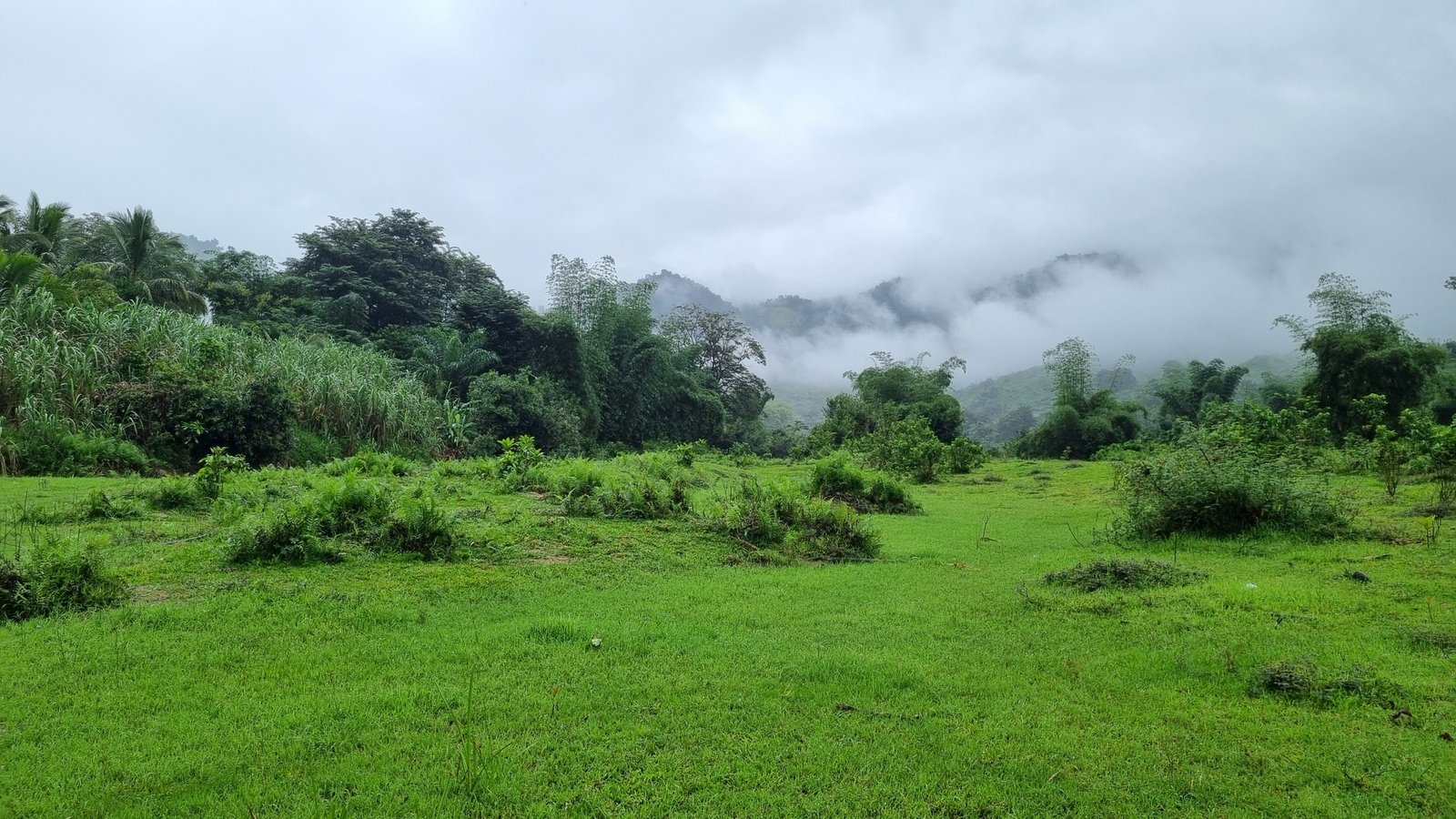 Clouds rolling over a green valley