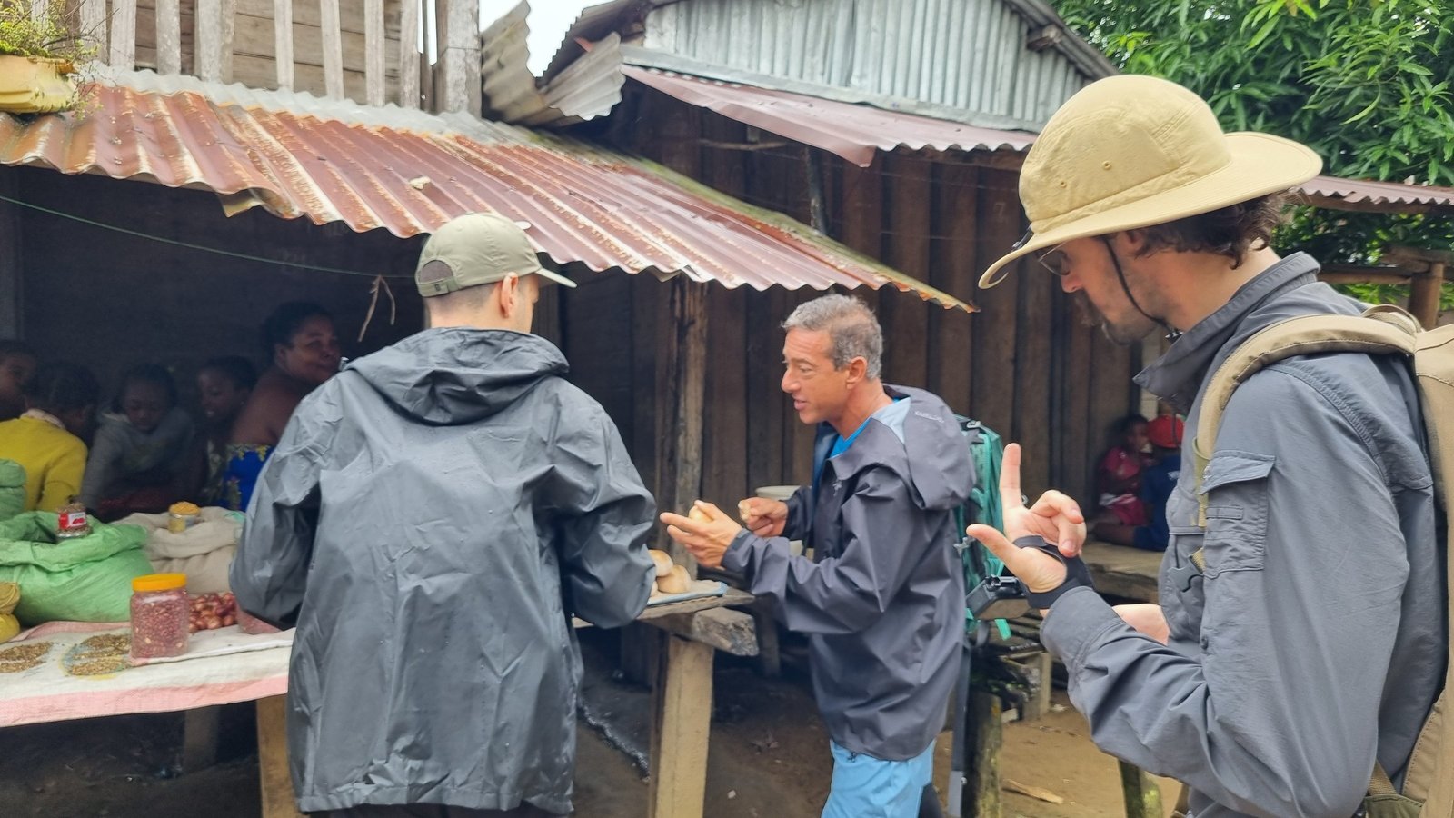 The team talking with a local guide at a village market